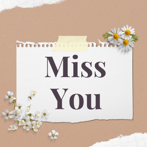 Miss You, white paper and flowers on it.