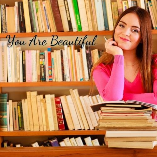 Girl looks beautiful  in her pink shirt and brown hair.
