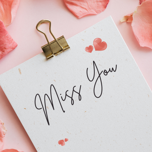Miss You, a white board on a pink wish card.